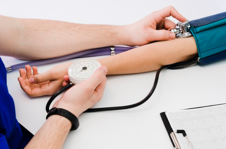 Doctor checking blood pressure